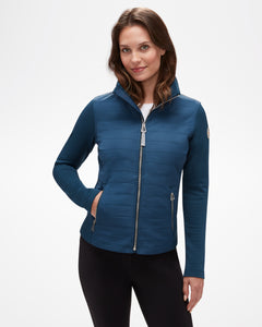 Aspen Collection Aether Morgan Technical Fleece Jacket, in blue. Vertical puff fabric on chest/core and fabric on arms. Silver zipper detail. View from front.