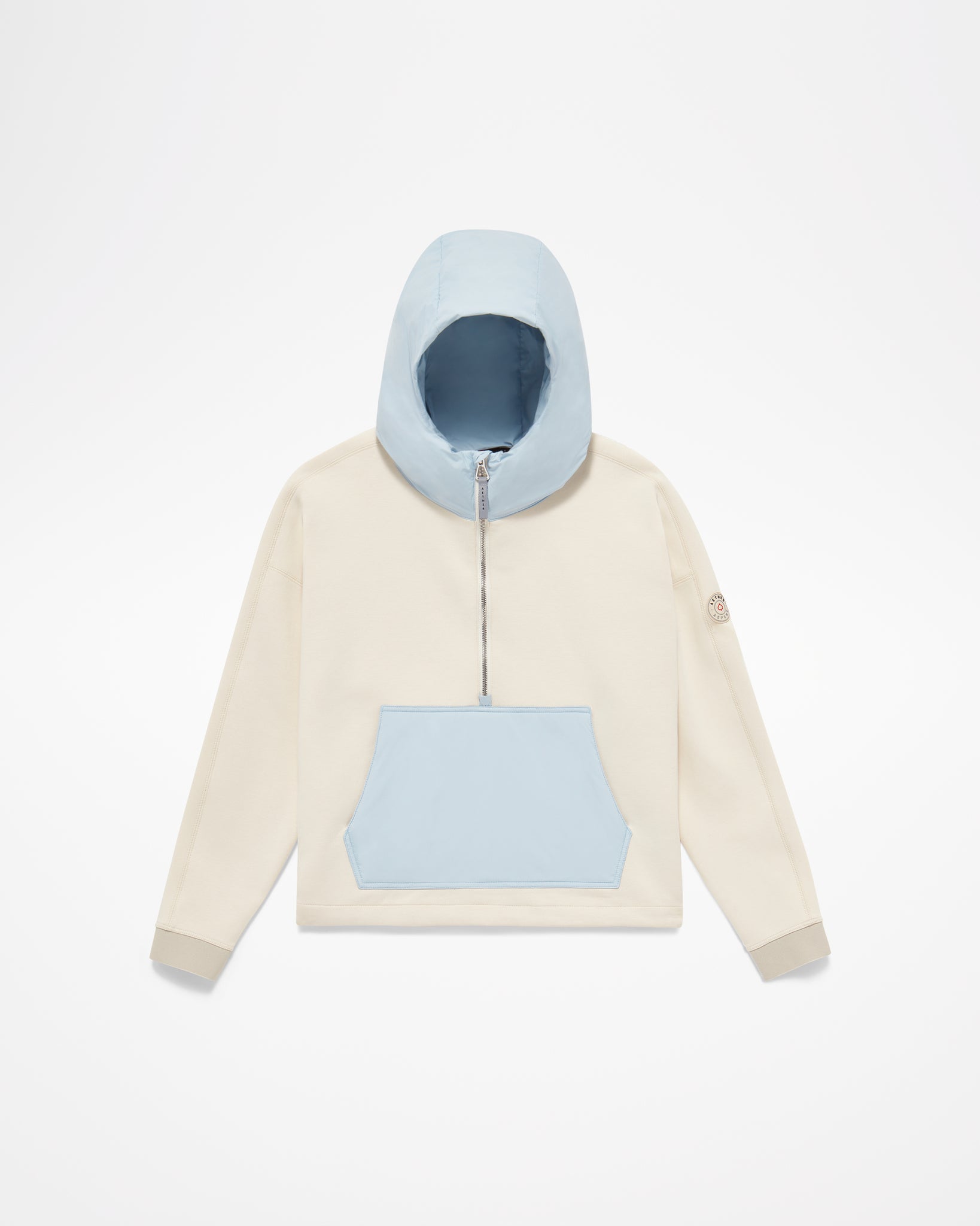 Aspen Collection Aether Align Hooded Anorak, without model. White jacket, light blue kangaroo puffer pouch and blue puffer hood, half zip