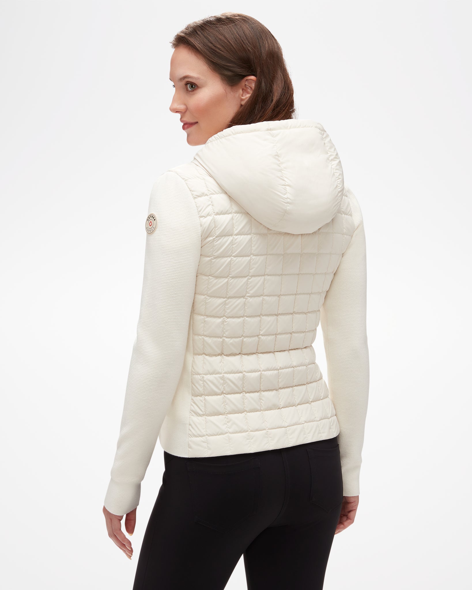 Aspen Collection Aether Phase Hooded Sweater, view from back, in white. Puffer fabric on back/core  and hood with white knit sleeves, patch on shoulder.