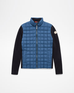 Aspen Collection Aether Phase Men's Full Zip Jacket, in Blue. blue puffer on chest/core of jacket. Black knit sleeves and patch on arm.