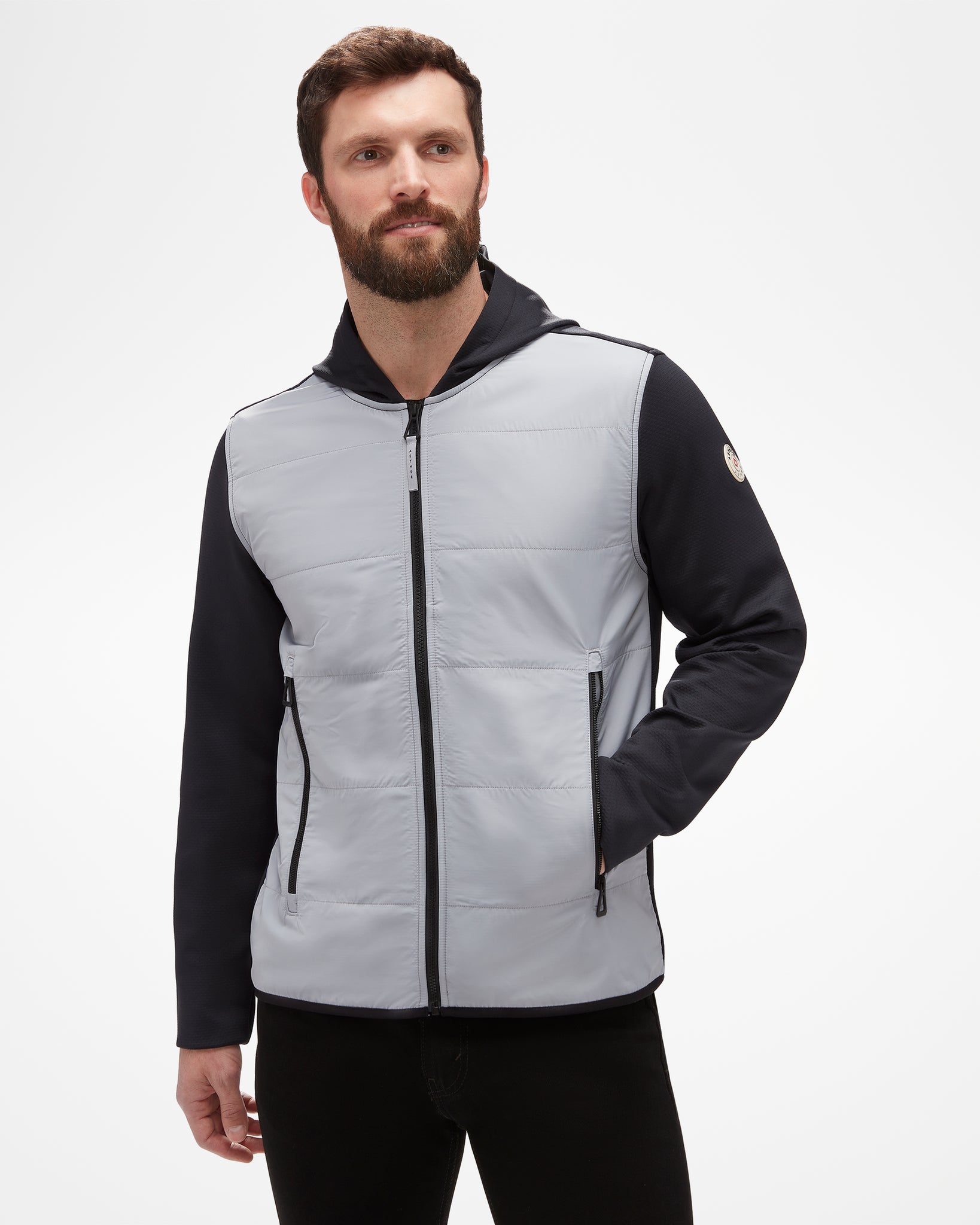 Aspen Collection Aether Morgan Technical Fleece Hoodie, vertical puff fabric in grey on chest, black athletic fabric on sleeves and hood. Aspen patch on sleeve