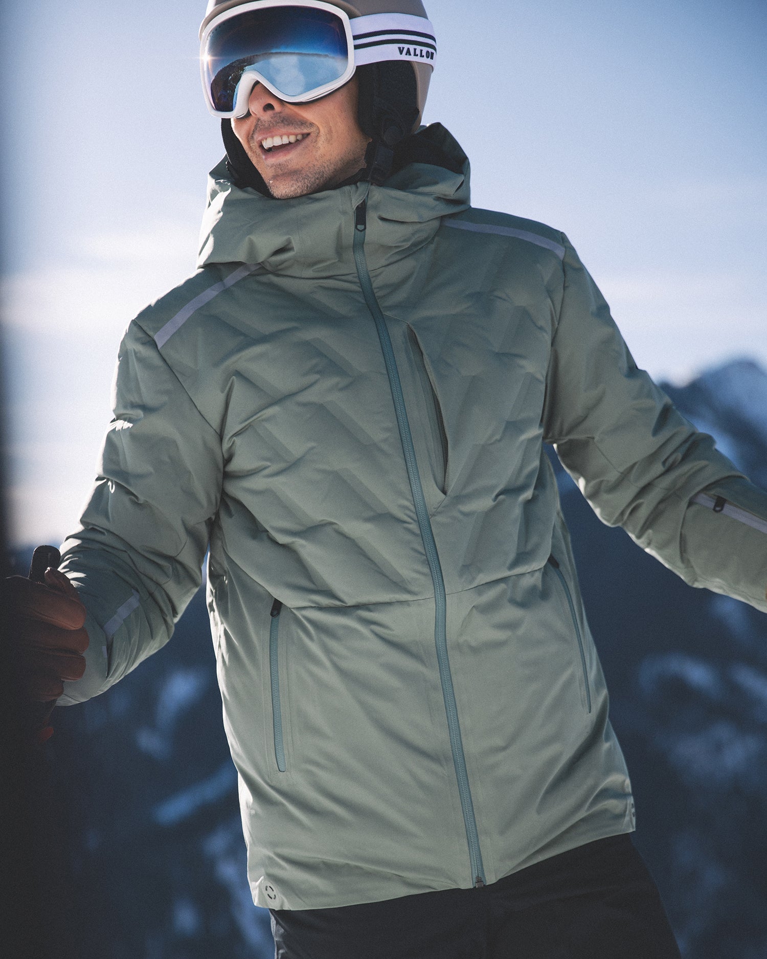 Men's mid-layer, puffy jacket that can be worn below larger jacket on cold day or provide a top layer on warmer days. Puff texture and chest pocket, in sage color