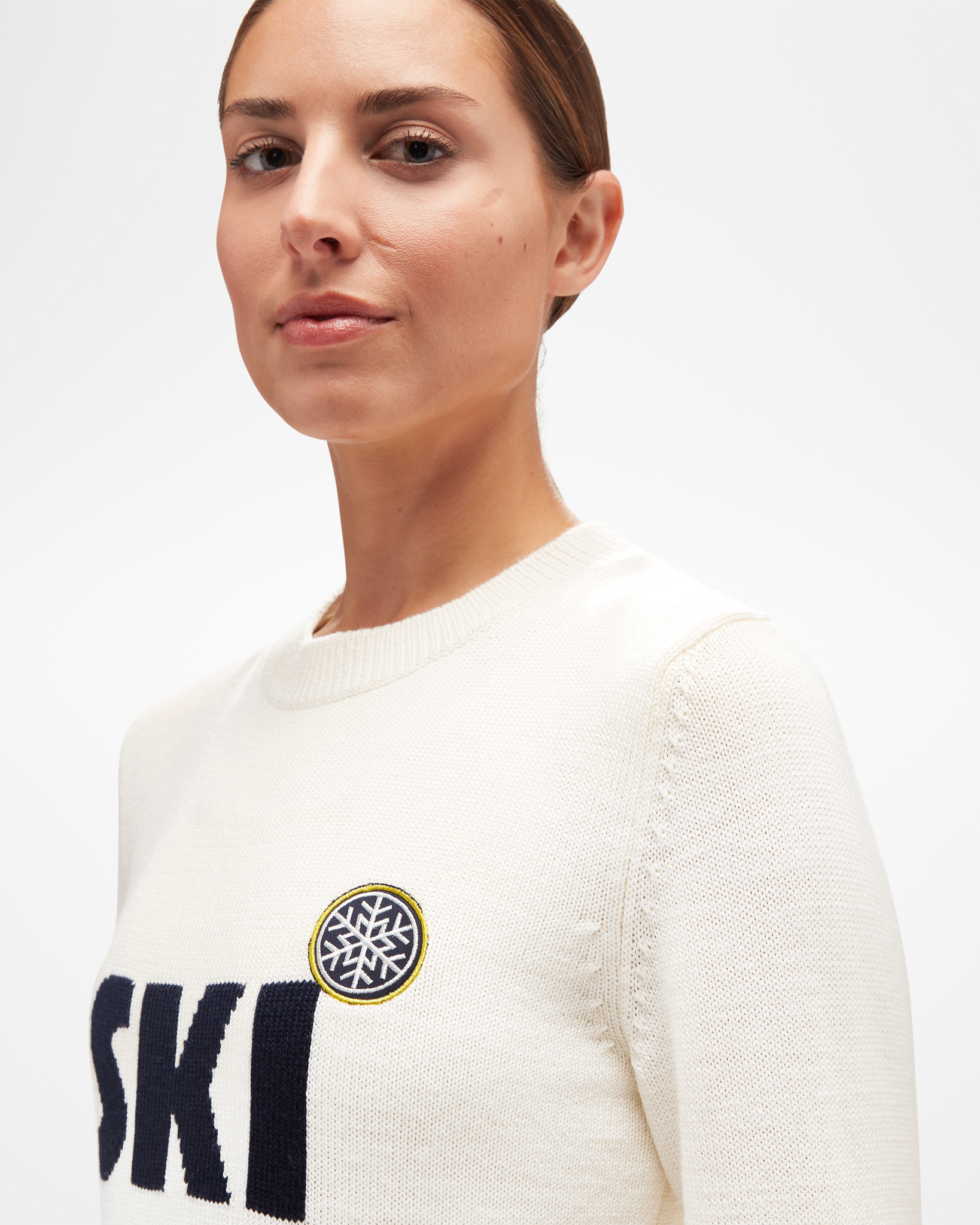 Women's Ski Sweater, in white merino wool, with black lettering, side view