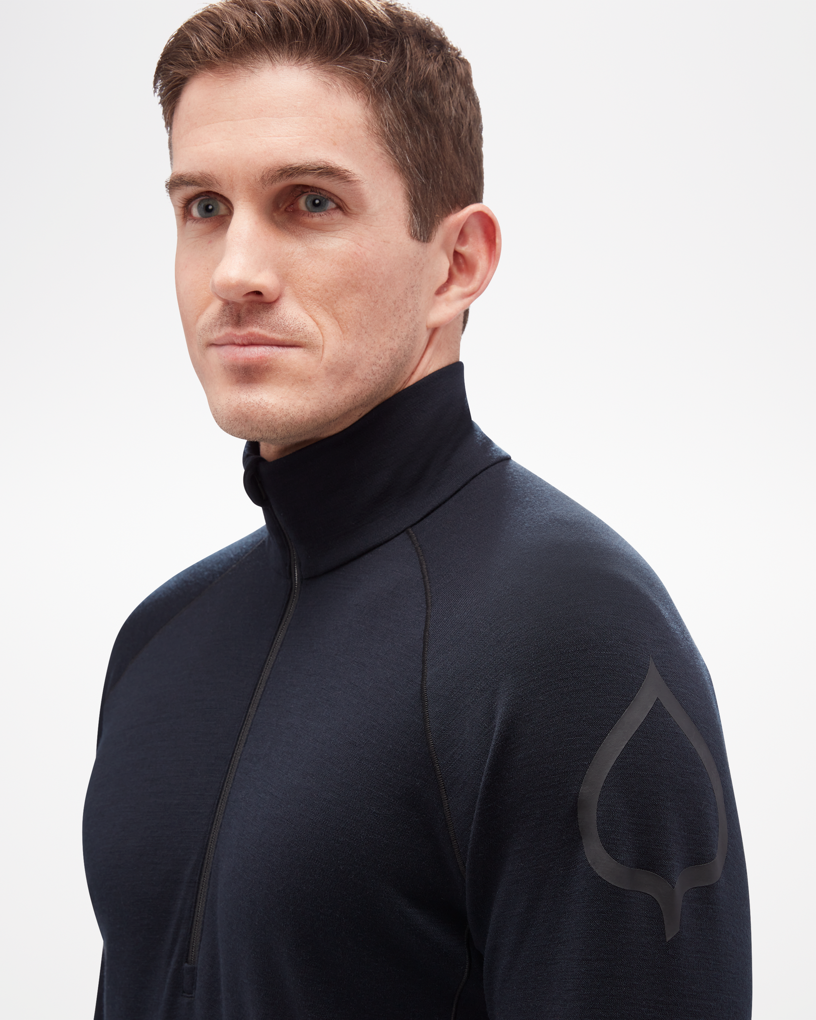 Aspen Collection men's mid layer top, made from merino wool. Close up detail shot  of quarter zip and logo