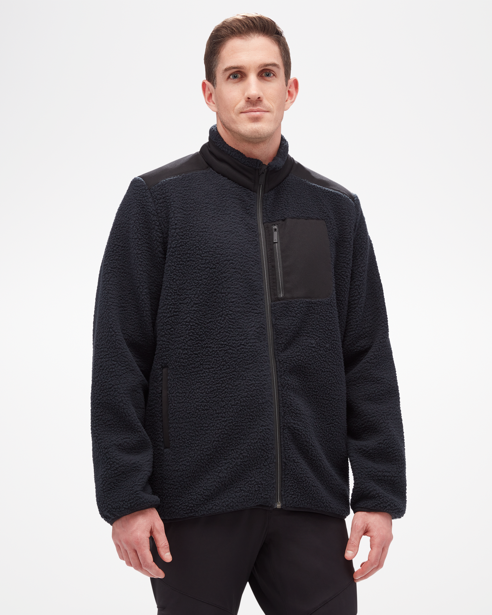 Aspen Collection high pile fleece, made from recycled material. Full zip with breast zip pocket, textured fabric on jacket, besides smooth breast pocket and shoulder fabric. Front view, in black