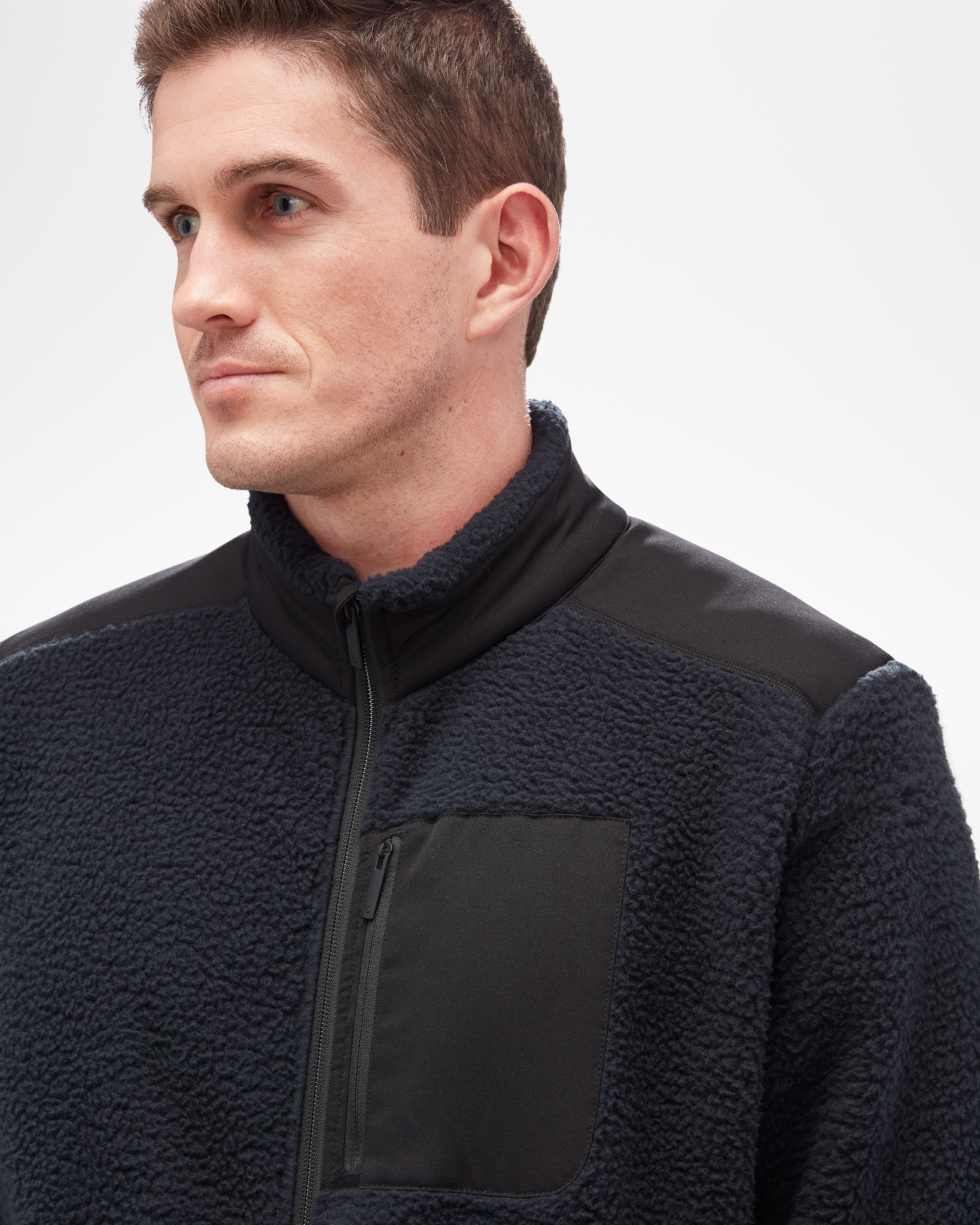 Aspen Collection high pile fleece, made from recycled material. Close up of full zip with breast zip pocket, and jacket texture