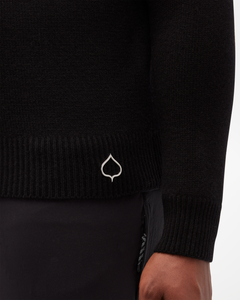 Aspen Collection men's Cashmere Crewneck, in black. Close up of wrist detail and aspen leaf logo