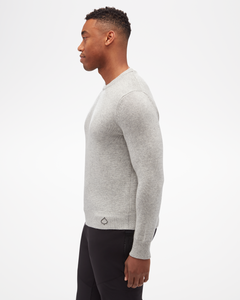 Aspen Collection men's Cashmere Crewneck, simple fitted knit, in grey color. Side view with small aspen leaf logo on bottom corner